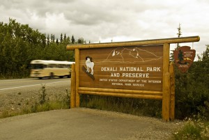 Denali National Park & Preserve Sign at gateway of park with bus in background