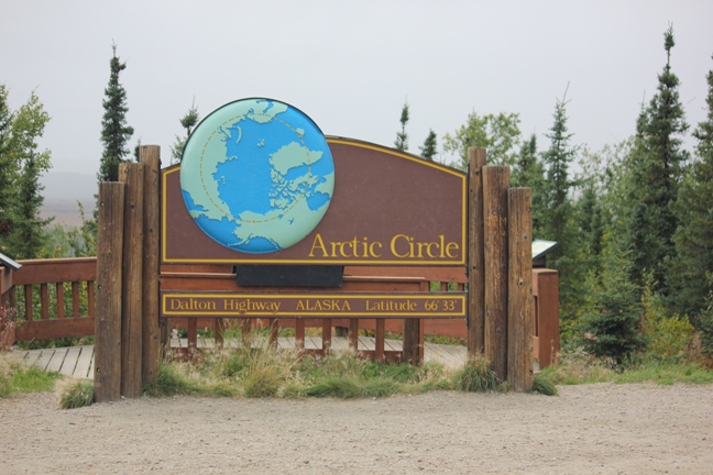 A sign welcomes visitors to the Arctic Circle