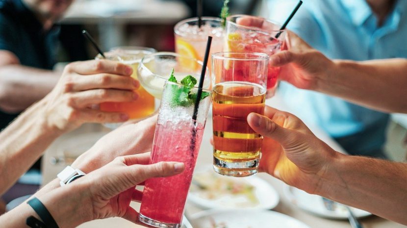 Friends toasting with summer cocktails