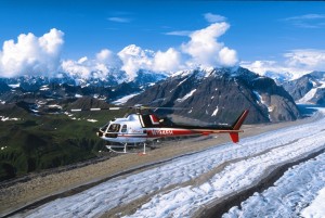 A helicopter flies over glaciers