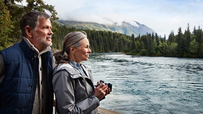 A couple overlooks the river at Kenai Princess Wilderness Lodge