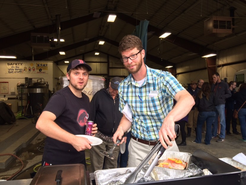 Employees prepare food over a grill